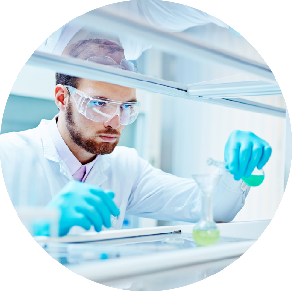Scientist with flasks at a lab.