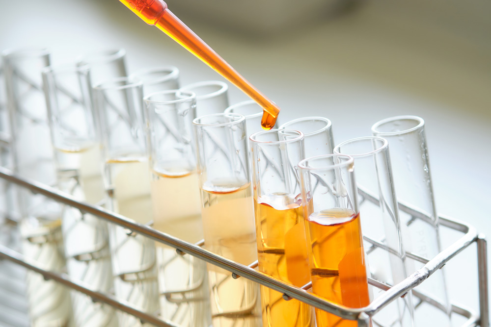 Equipment and glassware for test product extraction and orange color solution, in the chemistry laboratory.