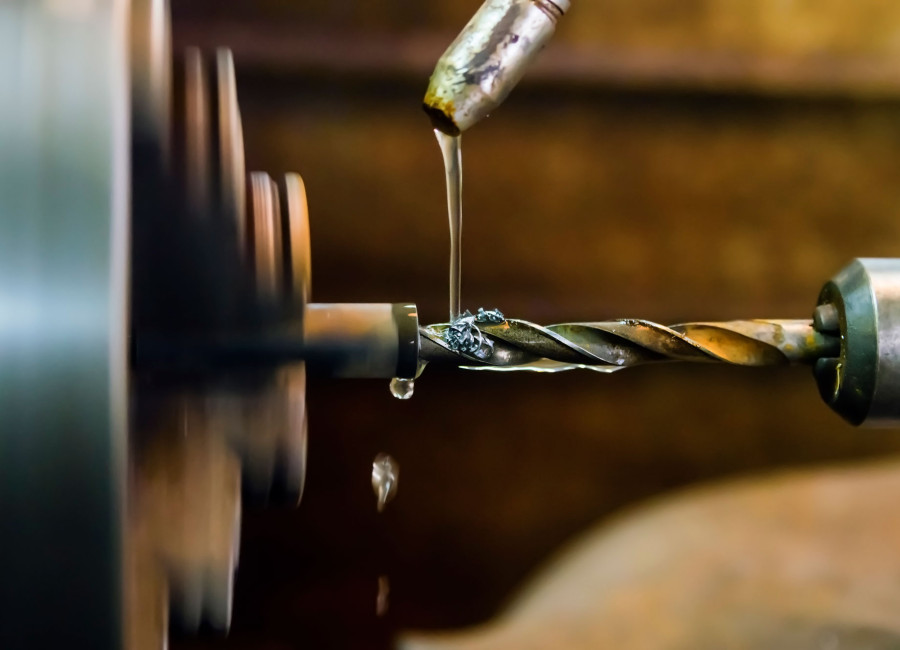 Close up of drill with lubricant application.